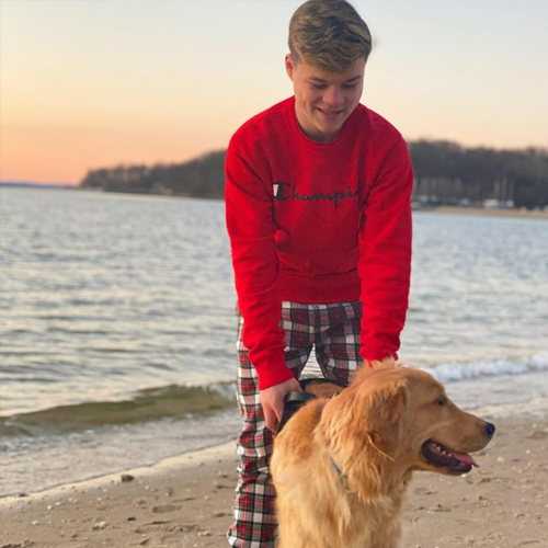 Cash on the lakeside beach with his best friend at sunset