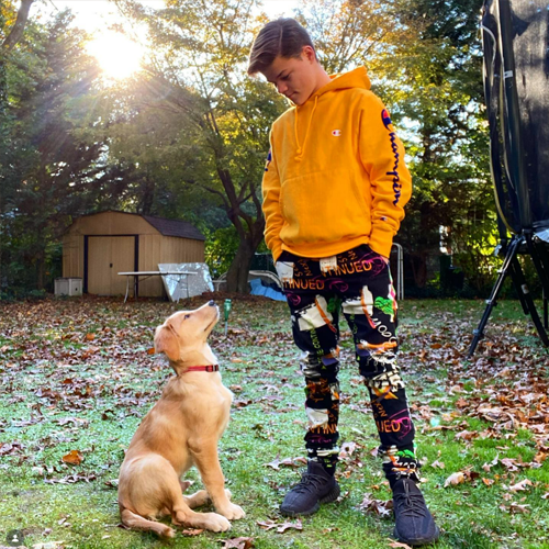 Young Cash Doherty looking up at his best friend in the backyard